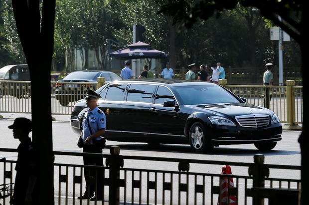 A car believed to be carrying North Korean leader Kim Jong Un drives down Chang'an Avenue towards Tiananmen Square in Beijing