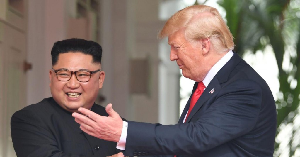 US President Donald Trump (R) shakes hands with North Korea's leader Kim Jong Un as they meet at the start of their historic US-North Korea summit