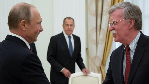 Russia's President Vladimir Putin (L) shakes hands with U.S. National Security Adviser John Bolton during a meeting at the Kremlin in Moscow