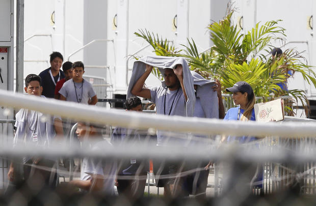 Migrant children walk outside at the Homestead Temporary Shelter for Unaccompanied Children a former Job Corps site that now houses them