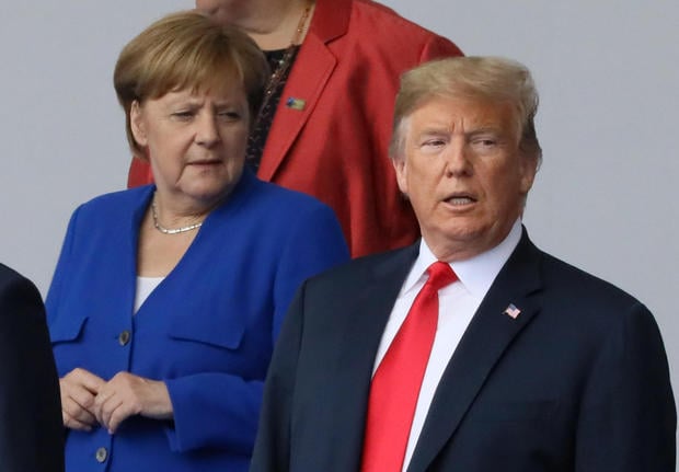German Chancellor Angela Merkel and U.S. President Donald Trump are seen as they pose for a family photo at the start of the NATO summit in Brussels
