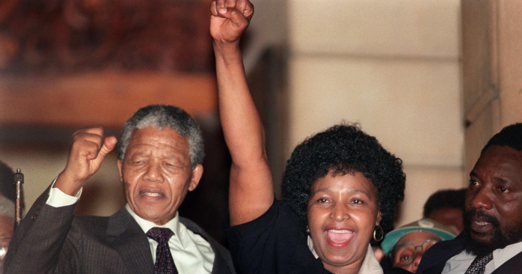 Anti-apartheid leader and African National Congress (ANC) member Nelson Mandela (L) and his then-wife Winnie raise their fists 11 February 1990 in Paarl to salute cheering crowd upon Mandela's release from Victor Verster prison.        (Photo credit should read WALTER DHLADHLA/AFP/Getty Images)