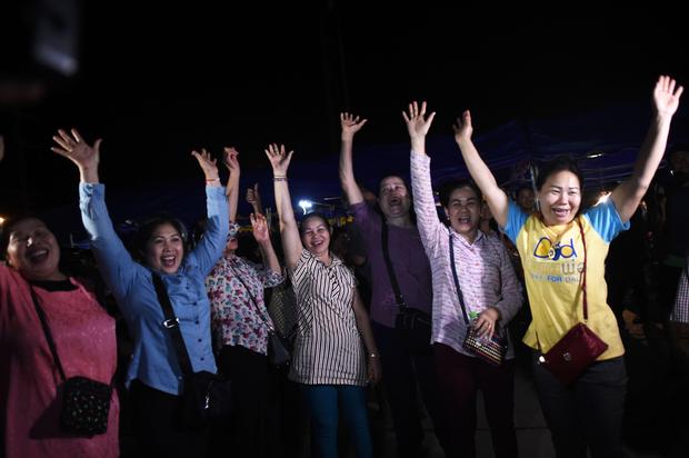Volunteers celebrate at a makeshift press centre in Mae Sai district of Chiang Rai province on July 10