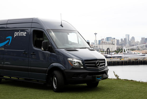 An Amazon Prime van sits on a hill overlooking downtown Seattle during a press conference announcing Amazon.com's new program to help entrepreneurs build businesses delivering Amazon packages