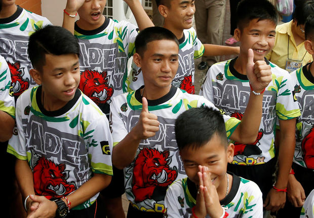 'Wild Boars' soccer players and their coach arrive for their news conference in Chiang Rai