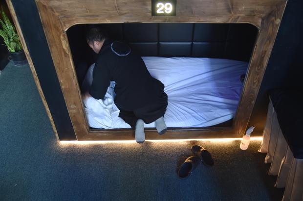 A worker prepares a cabin for a new client who can take a nap at Nap York
