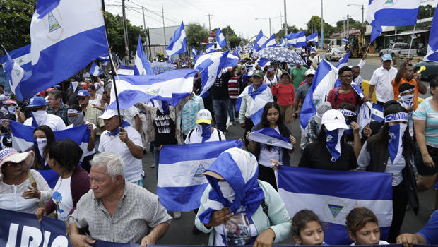 Anti-government marchers demand the resignation of President Daniel Ortega and the release of political prisoners in Managua