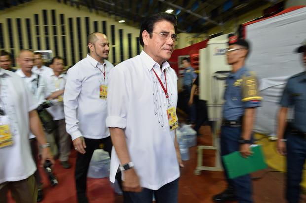 Tanauan mayor Antonio Halili (C) leaves the stadium after speaking to people who turned themselves in during the mass surrender of some 1
