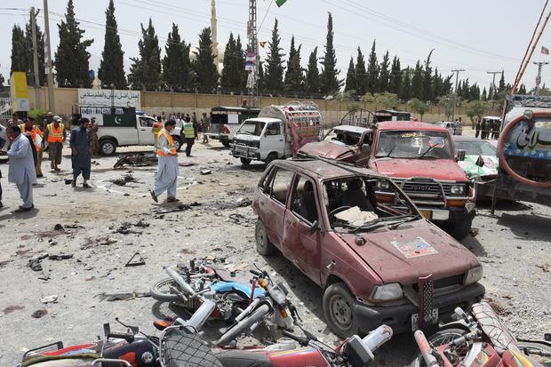 Pakistani security personnel gather at the site of a suicide attack near a polling station in Quetta on July 25