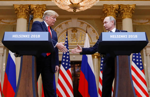 U.S. President Donald Trump and Russia's President Vladimir Putin shake hands during a joint news conference after their meeting in Helsinki