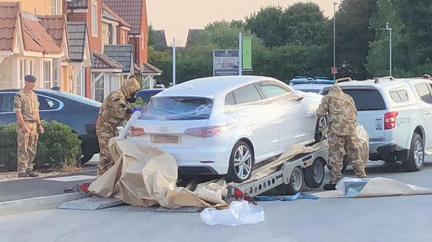 Personnel arrange the transportation of a car in relation to the ongoing nerve-agent incident in Amesbury