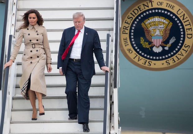 US President Donald Trump (R) and US First Lady Melania Trump disembark from Air Force One as they arrive at Melsbroek Air Base in Haachtsesteenweg on July 10