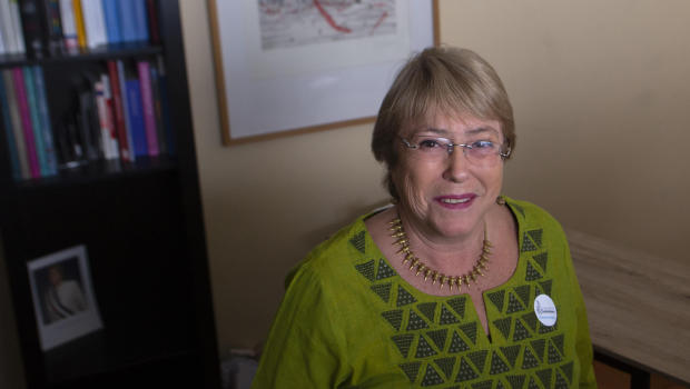 Former Chilean President Michelle Bachelet smiles for photographers before the inauguration of her Horizonte Ciudadano Foundation in Santiago