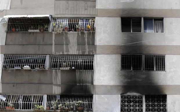 Signs of smoke cover the apartment complex where an allegedly armed drone crashed