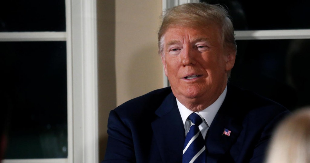 U.S. President Donald Trump waits for the press to leave after speaking at a dinner hosted by him with business leaders at Trump National Golf Club in Bedminster