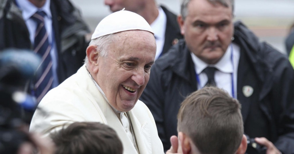 Pope Francis greets children as he disembarks from an airplane at Knock's airport