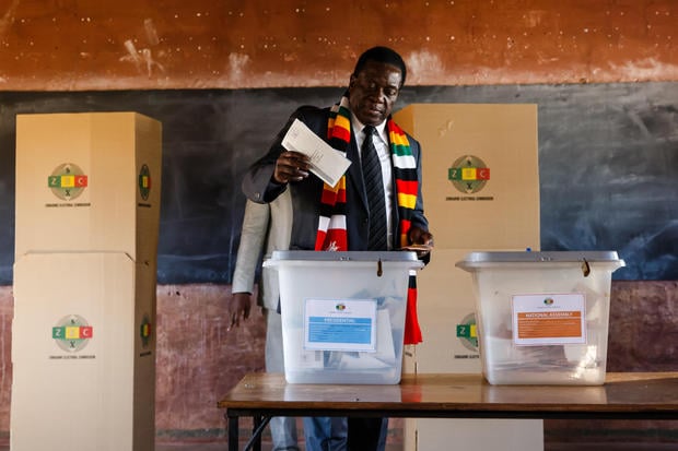 Zimbabwe President Emmerson Mnangagwa casts his ballot at Sherwood Primary School in Kwekwe on July 30 2018