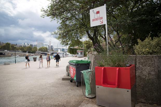 A picture shows a "uritrottoir" public urinal on August 13