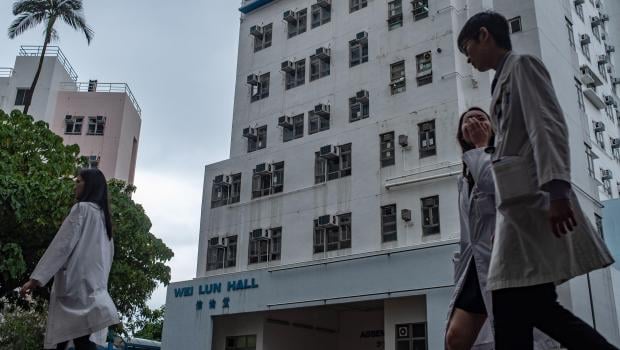 Students walk in front of University of Hong Kong's Wei Lun Hall