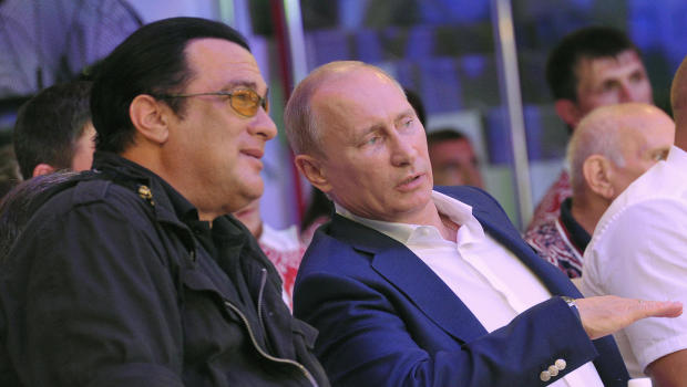 Russian President Vladimir Putin (R) speaks with US actor Steven Seagal (L) during the Mixed fight Championship in the Russian Black Sea resort of Sochi on August 11