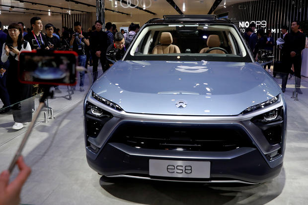 FILE PHOTO: Visitors check NIO ES8 displayed during a media preview of the Auto China 2018 motor show in Beijing