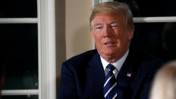 U.S. President Donald Trump waits for the press to leave after speaking at a dinner hosted by him with business leaders at Trump National Golf Club in Bedminster