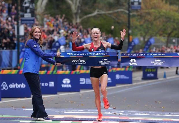 Shalane Flanagan crosses the finish line first in the women's division of the New York City Marathon in New York