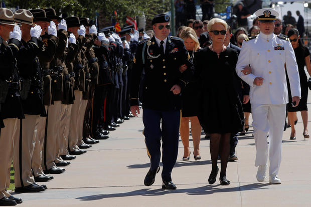 U.S. Senator John McCain's wife Cindy and their sons James (L) and John (R) follow Senator McCain's casket into the Arizona State Capitol where he will lie in state in Phoenix