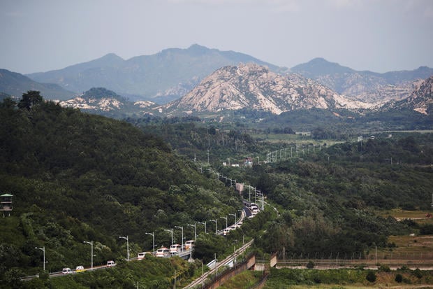 Buses transporting South Korean participants for a reunion travel on the road leading to North Korea's Mount Kumgang resort