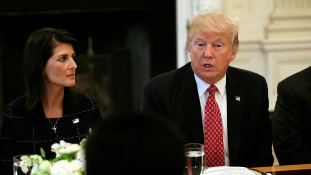 With U.S. Ambassador to the United Nations Nikki Haley at his side (L)
