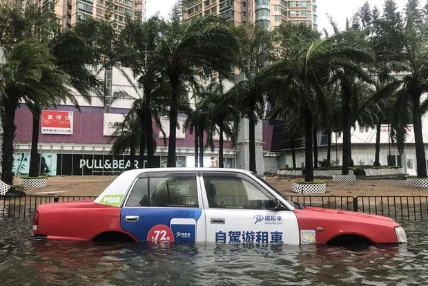 A taxi is left abandoned after breaking down in floodwaters during Super Typhoon Mangkhut in Hong Kong on September 16