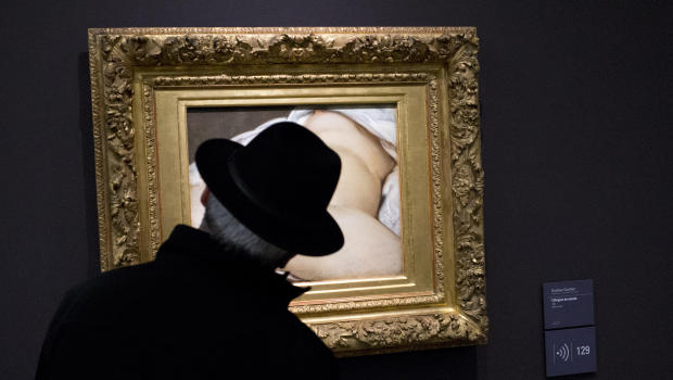 A visitor looks at Gustave Courbet's 1866 "The Origin of the World