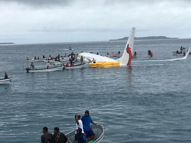 People are evacuated from an Air Niugini plane crashed in the waters in Weno