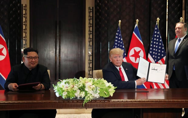 U.S. President Donald Trump shows the document
