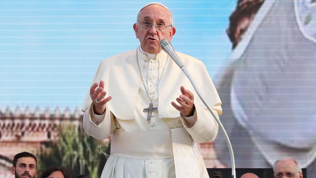 Pope Francis reacts as he meets with young people at the Politeama square in Palermo