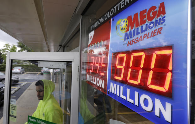 The Mega Millions jackpot is displayed as a customer leaves the Corner Market