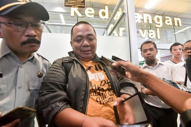 Sony Setiawan (C) speaks to journalists at Pangkal Pinang airport in Bangka Belitung province on October 29