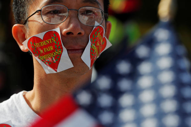 A man wearing stickers on his face attends the "Rally for the American Dream - Equal Education Rights for All