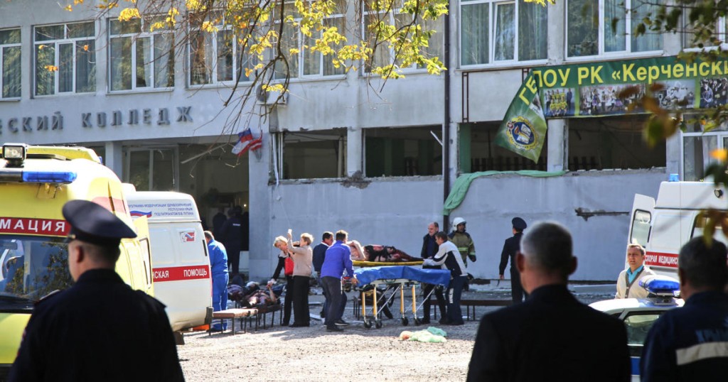 Rescuers carry an injured victim of a blast at at a college in the city of Kerch on October 17