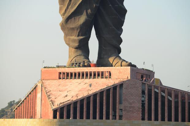 Indian construction workers are seen at the plimth structure the "Statue Of Unity"