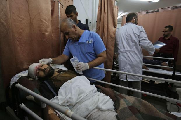 Wounded Palestinian men lie in Najjar hospital in the southern Gaza Strip city of Rafah on October 17