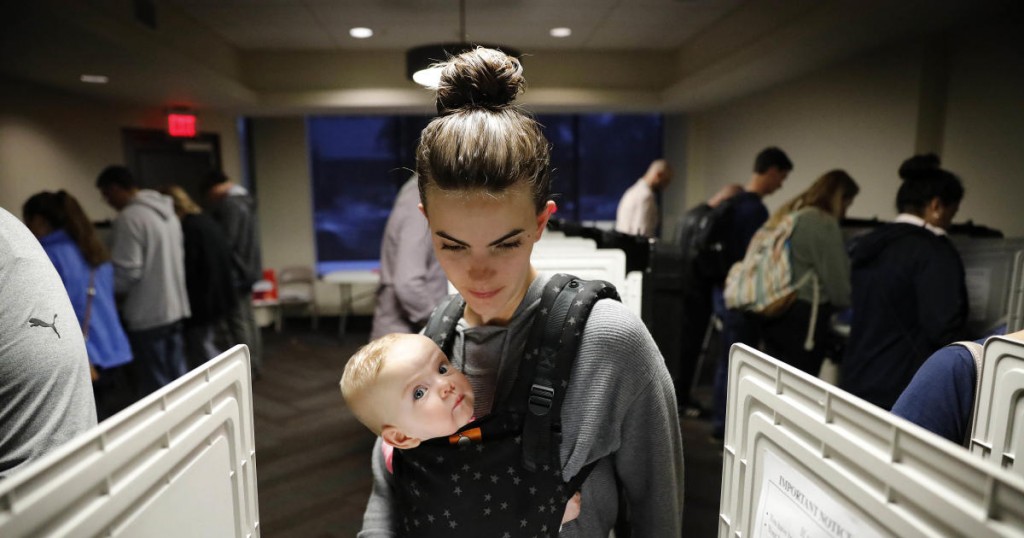 Kristen Leach votes with her six-month-old daughter