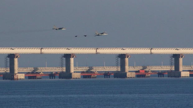Russian jet fighters fly over a bridge connecting the Russian mainland with the Crimean Peninsula after three Ukrainian navy vessels were stopped by Russia from entering the Sea of Azov via the Kerch Strait in the Black Sea