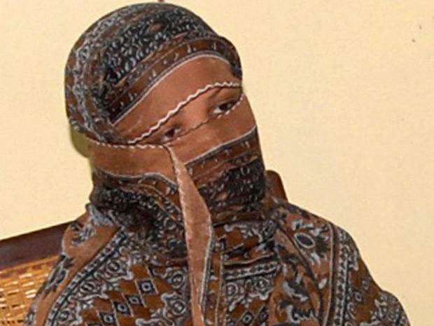 Asia Bibi, a Pakistani Christian woman, looks on as the governor of Punjab province, Salman Taseer, speaks to reporters at a jail in Sheikhupura, Pakistan, Nov. 20, 2010. 