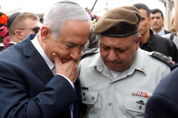 Israeli Prime Minister Benjamin Netanyahu chats with Israeli Chief of Staff Lieutenant-General Gadi Eizenkot as they attend an annual state memorial ceremony for Israel's first prime minister
