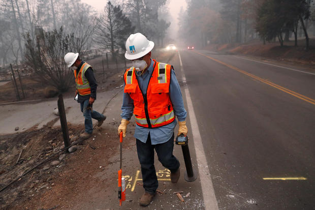 Employees of Pacific Gas & Electric (PG&E) mark gas lines in the aftermath of the Camp Fire in Paradise