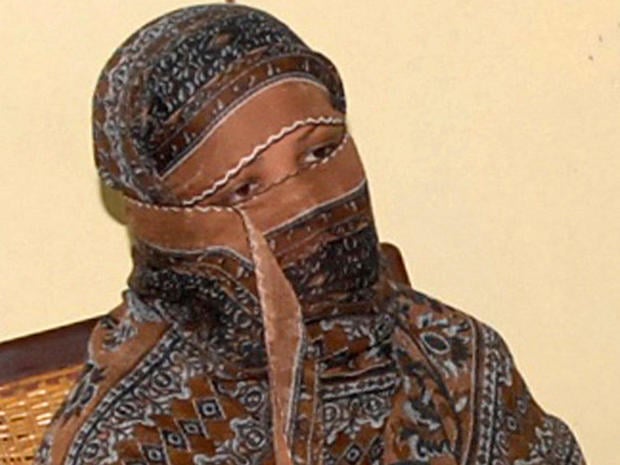 Asia Bibi, a Pakistani Christian woman, looks on as the governor of Punjab province, Salman Taseer, speaks to reporters at a jail in Sheikhupura, Pakistan, Nov. 20, 2010. 