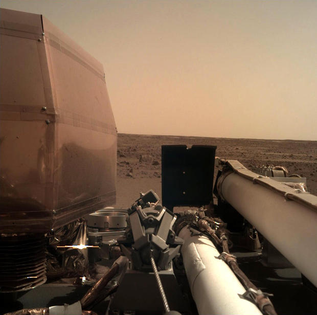 This photo provided by NASA shows an image on Mars that its spacecraft called InSight acquired using its robotic arm-mounted