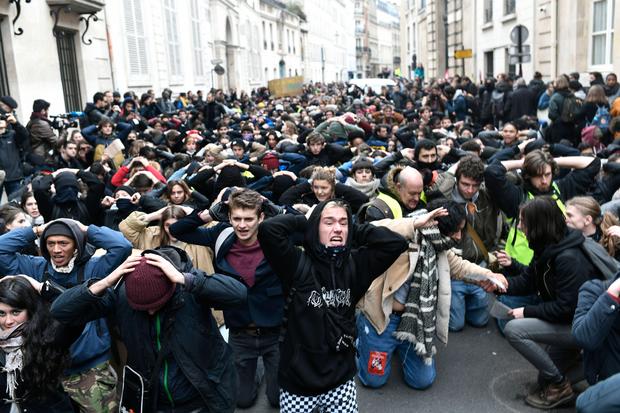 TOPSHOT - High school students demonstrate on their knees on December 11
