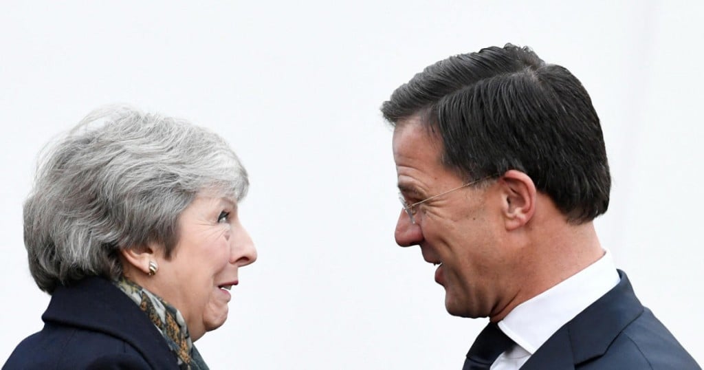 British Prime Minister Theresa May is welcomed by Dutch Prime Minister Mark Rutte ahead of a meeting in the Hague